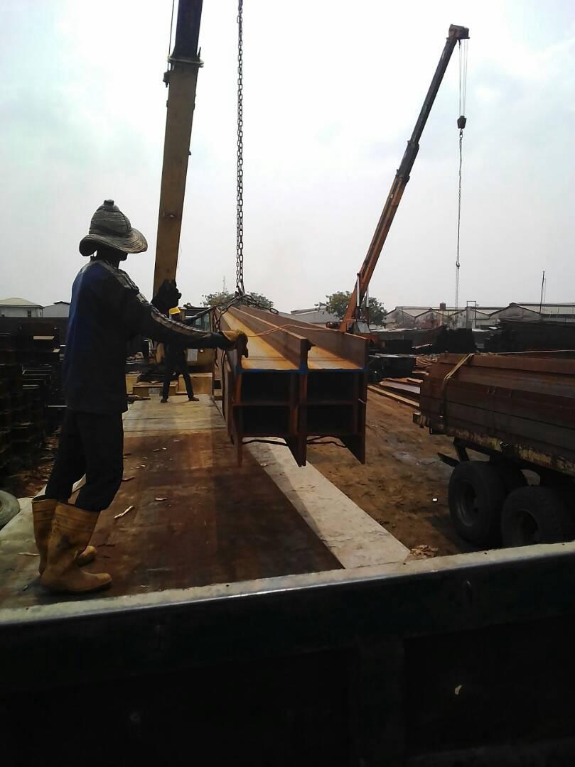 Worker guiding suspended steel beams